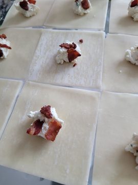 prepping the filled wonton wrapper with borsain cheese and bacon