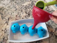 filling ball ice molds with blue tea