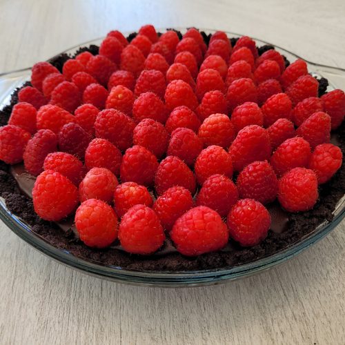 chocolate grenache pie with oreo cookie crust and whole raspberries topping