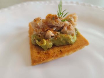 crab and avocado with dill on a pita chip