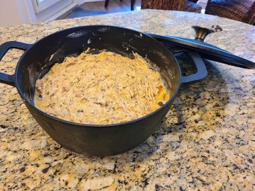 breadpudding mixture with pecan topping in cast-iron dutch oven