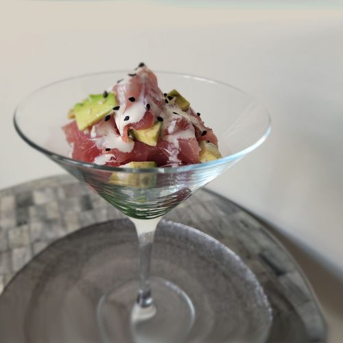 ahi tuna poke in martini glass with avocado slices