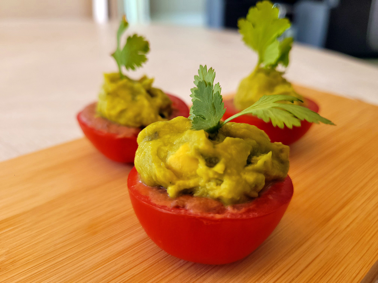 Campri tomatoes stuffed with black bean hummus and spicy guacamole