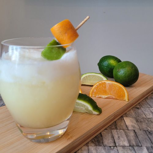 Tropical Rum cocktail with orange and limes