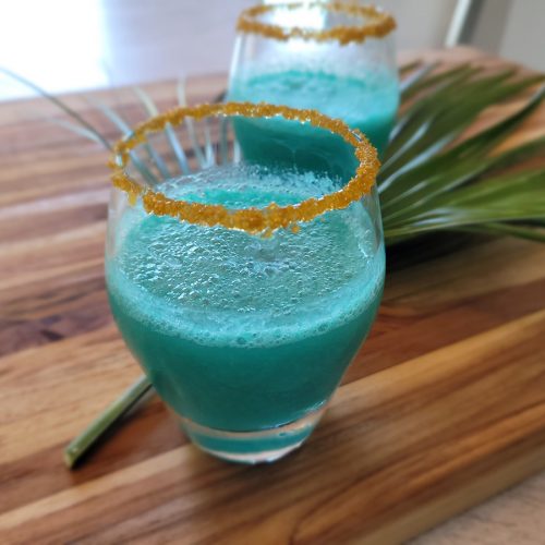 blue alcoholic drink rimmed with yellow sugar