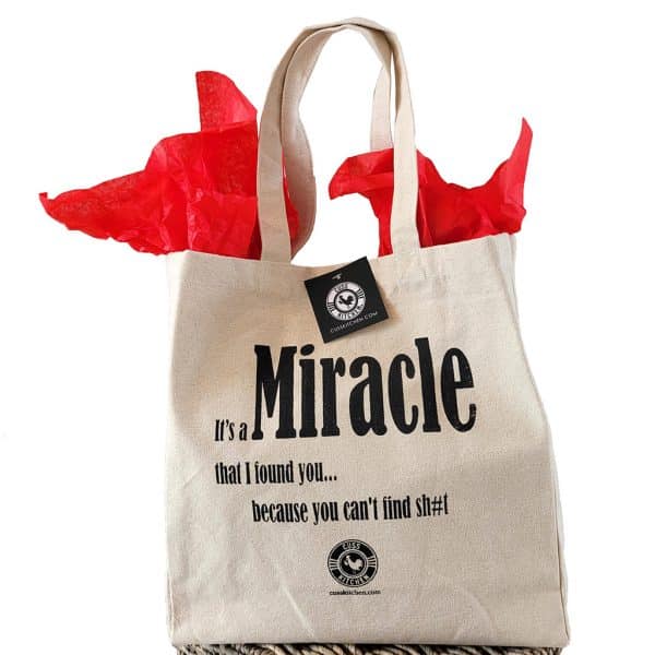 Canvas gift bag that says "It's a Miracle that I found you...because you can't find sh#t"