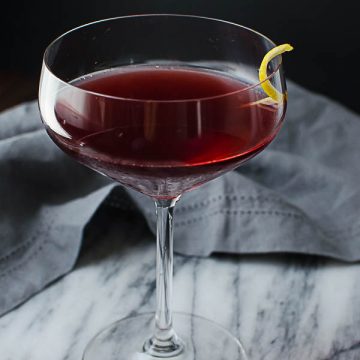 cocktail of pomegranate juice, vodka and amaretto in a champagne glass