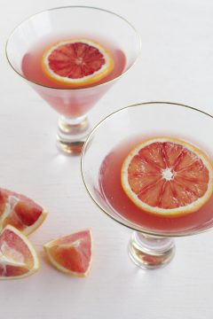 Blood orange pomegranate Martini with a lemon slice