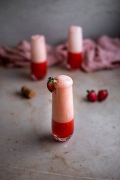 bubbly pink drink garnished with strawberry recipe by ANerdCooks.com