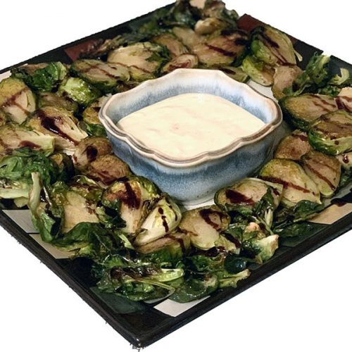 platter of roasted brussel sprouts with creamy dipping sauce