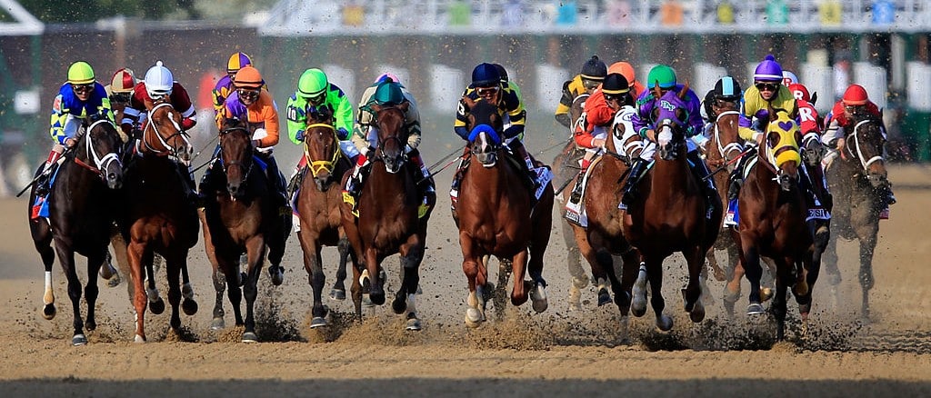 Racing Horses with brightly colored jockeys