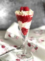 layered dessert with creme and raspberries