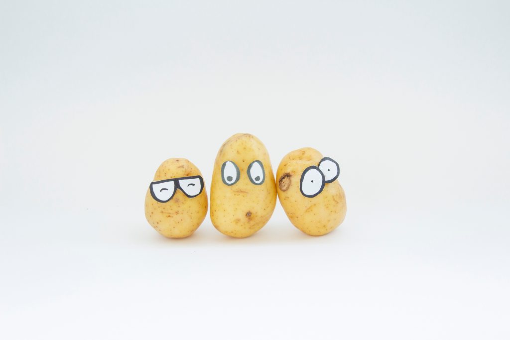 3 potatoes with cartoon glasses on
