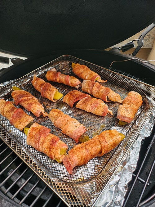 bacon wrapped pickles on the grill