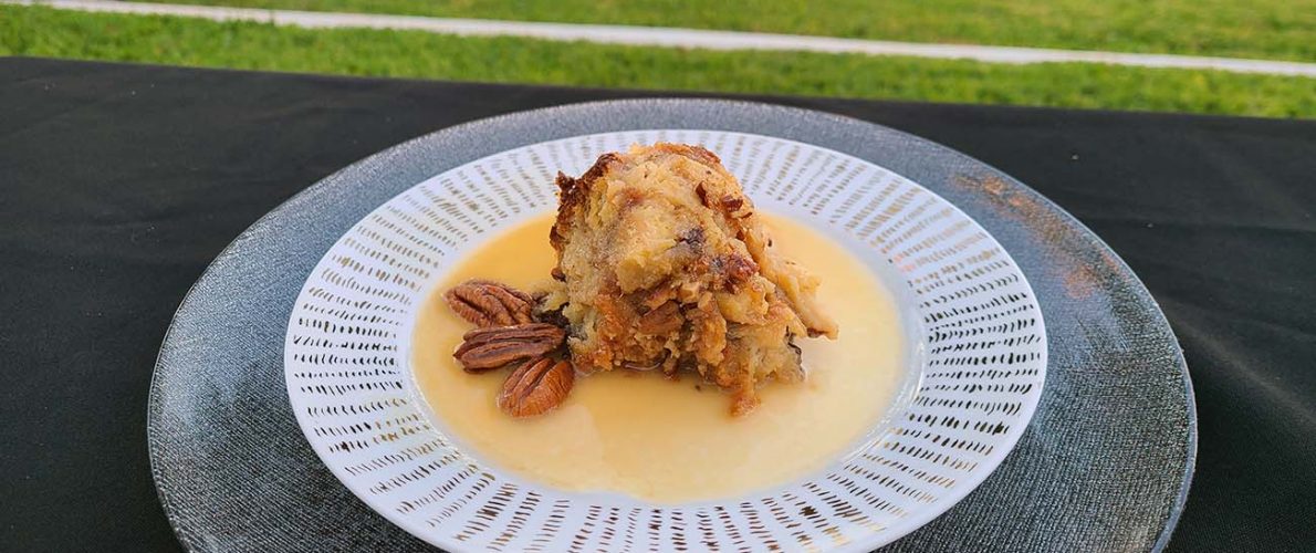 plate of southern bread pudding with pecans and buttery bourbon glaze