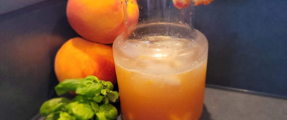 Peach moonshine with cardamom bitters