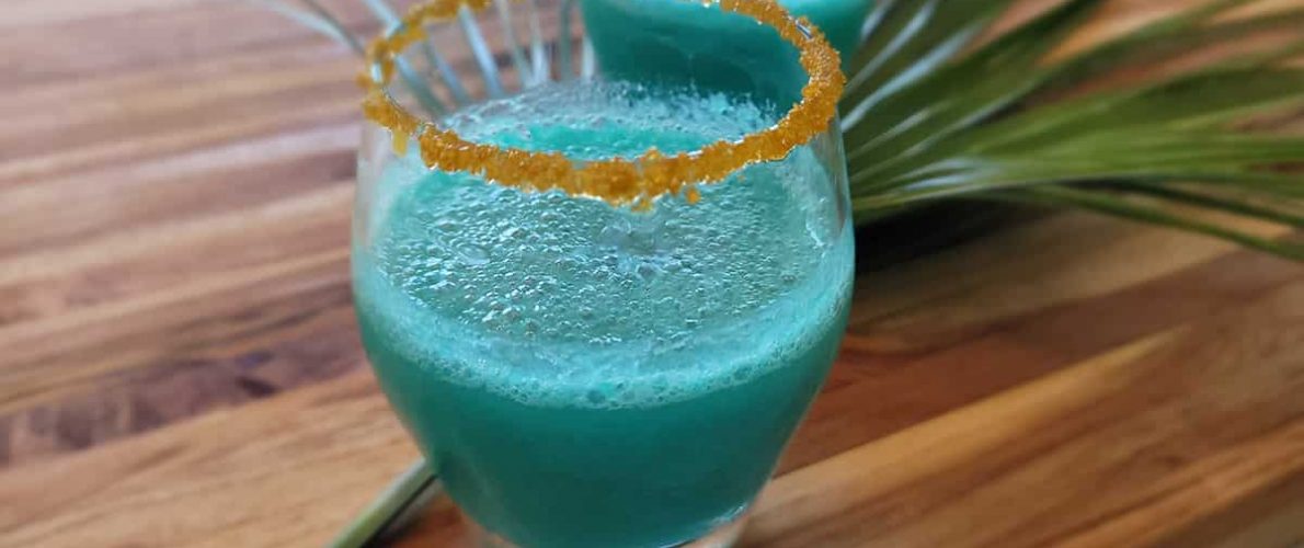 blue alcoholic drink rimmed with yellow sugar